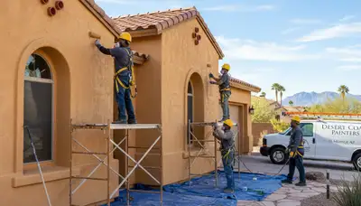 Painting contractor in Phoenix, AZ painting a home exterior for residential repainting services