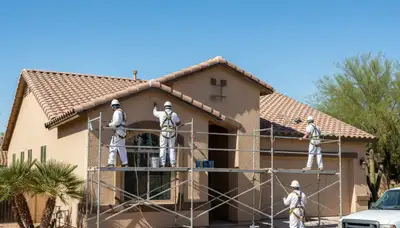 Professional Phoenix, AZ house painters preparing an exterior home for painting